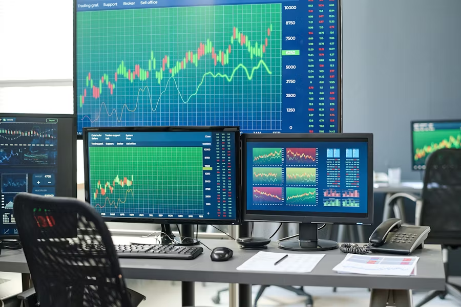 horizontal-no-people-shot-of-stock-and-currency-trading-agents-workspace-with-desktop-computers-and-various-monitors-in-modern-office-interior