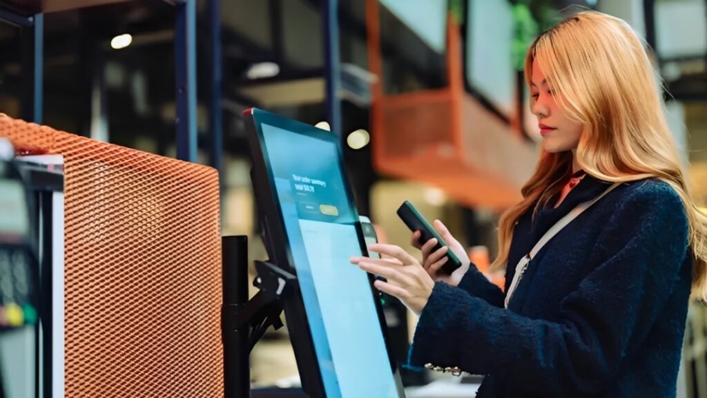 women-in-casual-clothing-paying-using-automatic-payment-machine