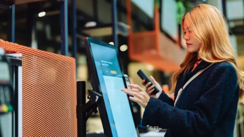 women-in-casual-clothing-paying-using-automatic-payment-machine