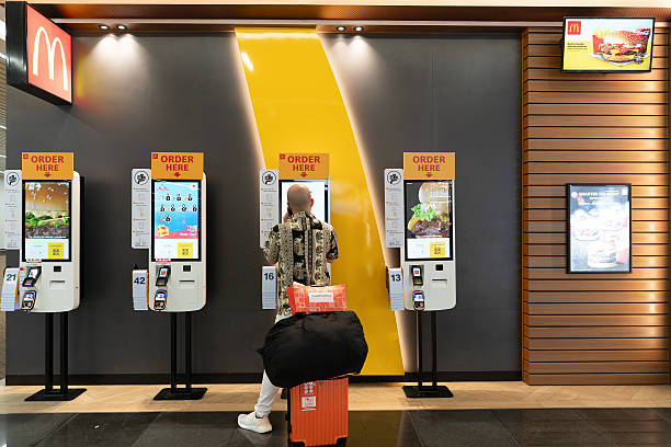 A view of four self-order kiosks at the McDonald's restaurant.