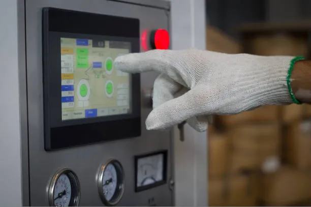 Worker Hand In A White Glove Presses On The Touch Screen Control Panel Equipment In The Factory.