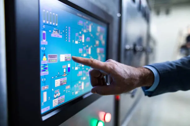 Close Up Of An Inspector Working On Touch Screen Of Production Machine