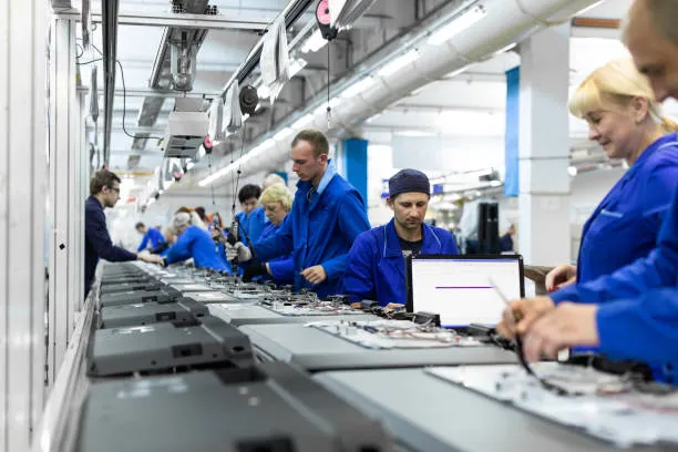 Workers On The Conveyor For The Production Of Televisions. Testing TVs In The Workshop.