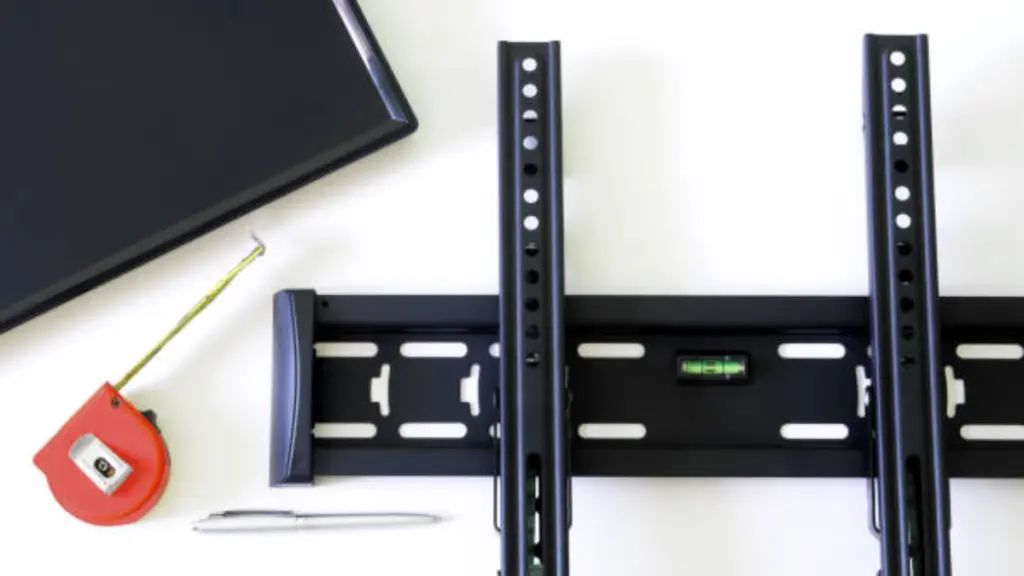 Wall Bracket For TV Or Monitor, Fountain Pen, Tape Measure And Monitor Screen On A White Background