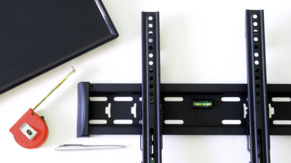 Wall Bracket For TV Or Monitor, Fountain Pen, Tape Measure And Monitor Screen On A White Background