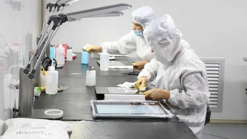 Workers Manufacturing Touch Screen Monitors