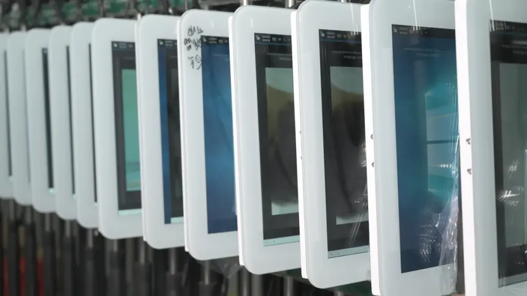 A Row of Touchscreen Monitors Undergoing Factory Burn In Testing