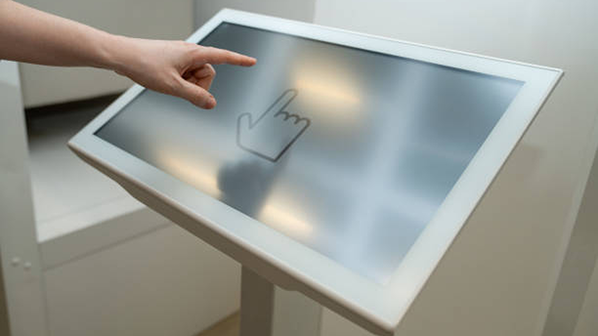 Woman Uses The Self Service Kiosk